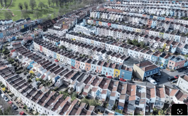 Aerial view of a UK residential neighbourhood representing multiple retrofit properties being managed across different project stages.